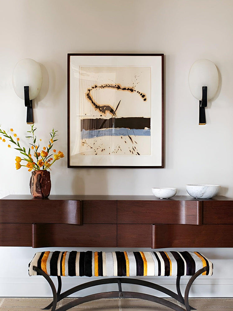Pair of Modern Alabaster Oval Stem Wall Sconces framing artwork