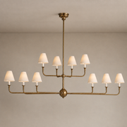 Tiered Brass and Fabric Linear Chandelier product view on a warm neutral background, view 1