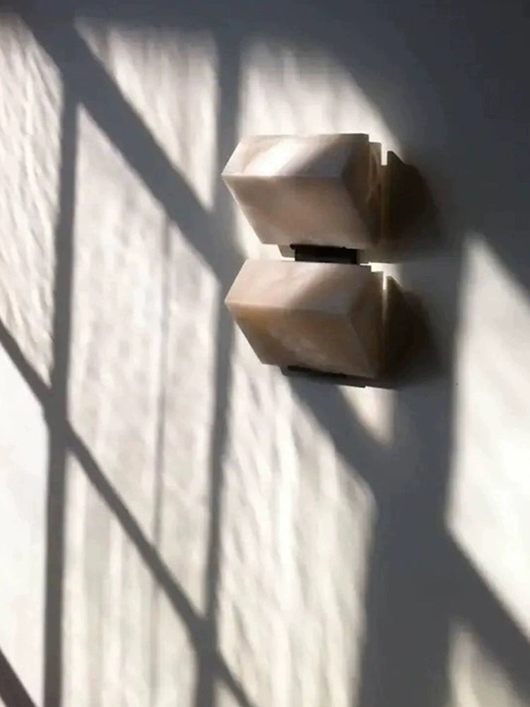 Two Modern Alabaster Geometric Wall Sconces casting angular shadows