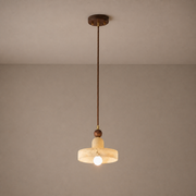 Alabaster and walnut disc pendant light on a neutral background