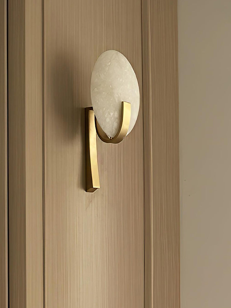 Angled view of the Modern Alabaster Oval Stem Wall Sconce on wood paneling