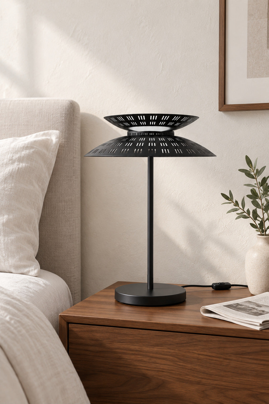 Black Coffee Asterune table lamp beside a bed, light off