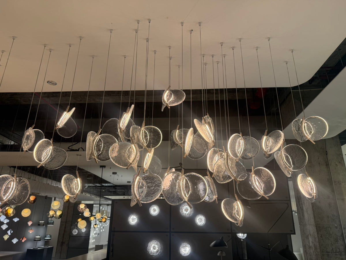 Clear Blown Glass Petal Cascade Chandelier photographed in the ARDEN LUME showroom, wide installation view