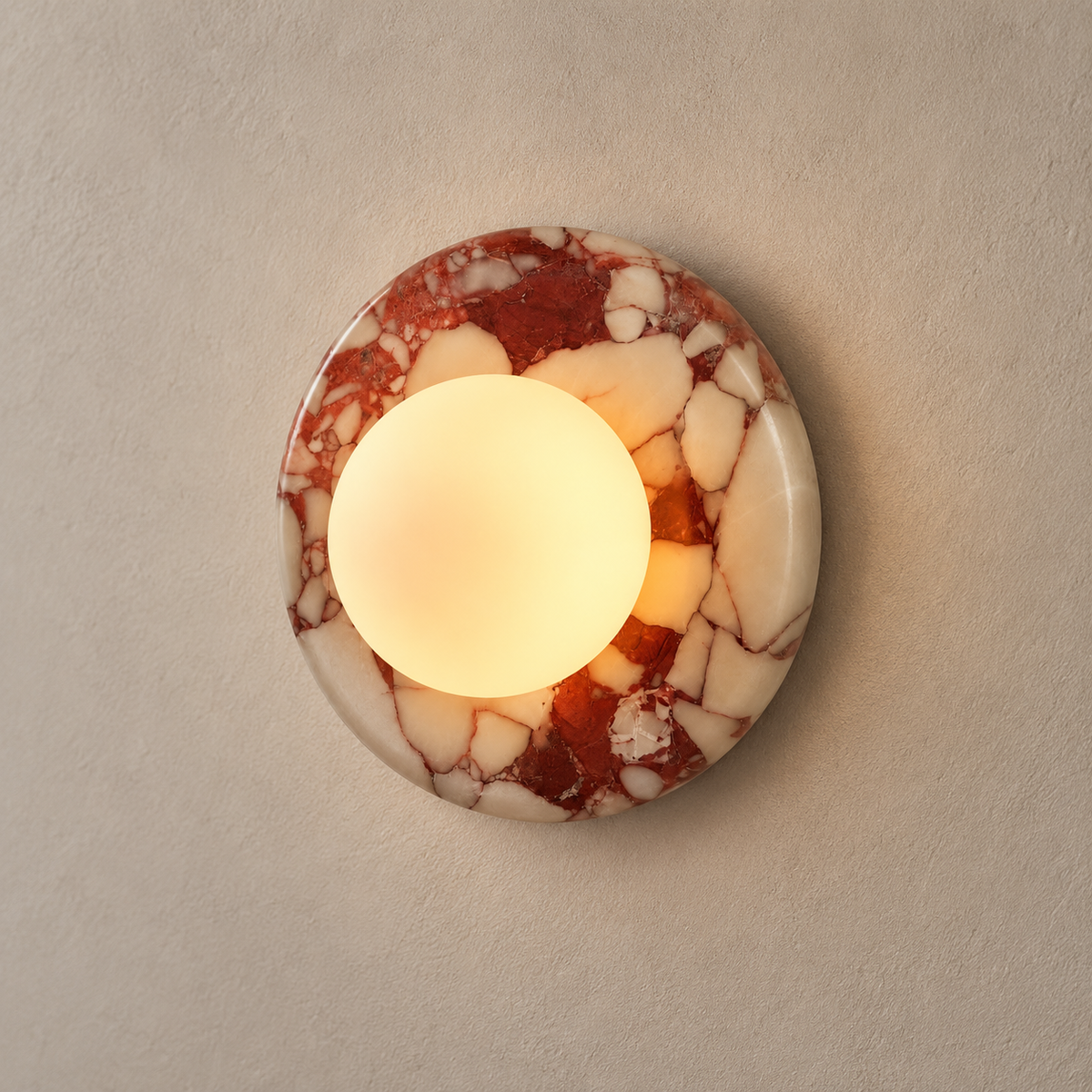 Orli Red Marble Globe Wall Sconce on a warm greige background