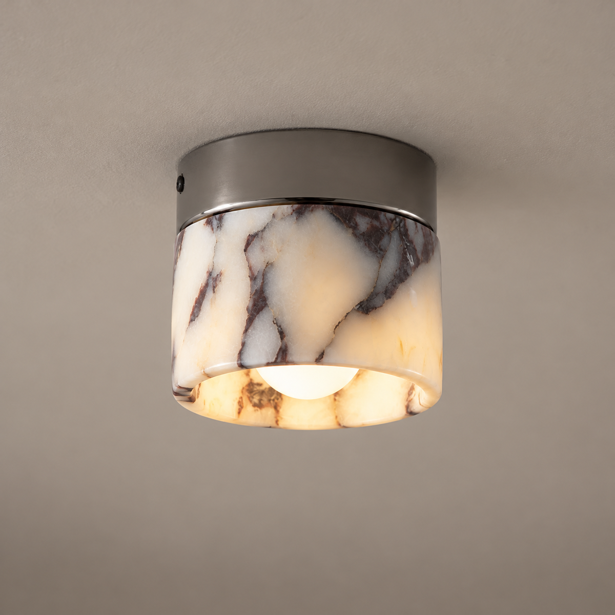 Minimalist Marble Round Ceiling Light on a warm greige background; White veined marble cylinder, gunmetal grey flush ceiling base