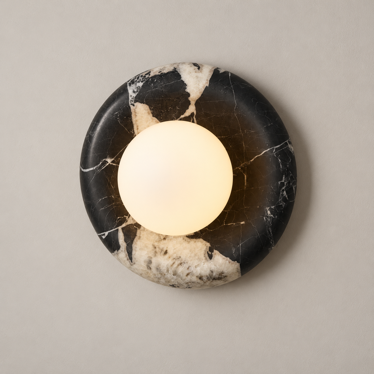 Orli Black Marble Globe Wall Sconce on a warm greige background