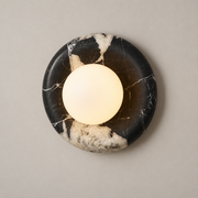 Orli Black Marble Globe Wall Sconce on a warm greige background