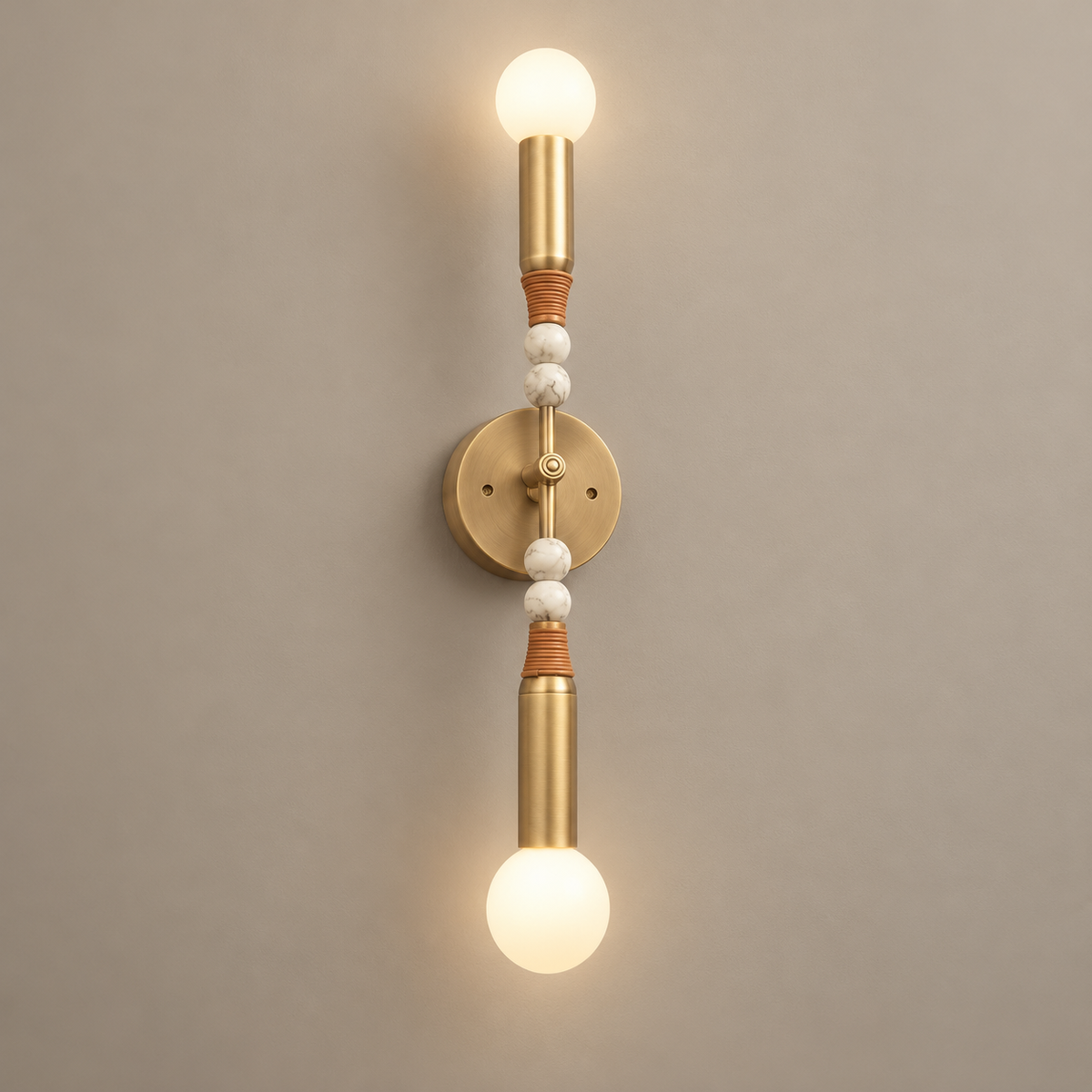 Toam Double Marble Wall Sconce on a warm greige background; Antiqued brass and white marble, four stone beads