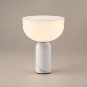 Kizu Marble Rechargeable Table Lamp on a warm greige background; White marble, portable rechargeable version