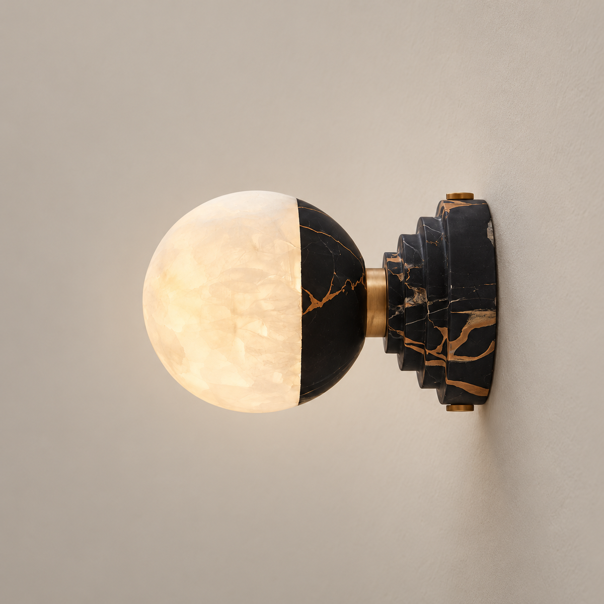 Lunar Organic Modern Marble Wall Sconce on a warm greige background; Black-gold marble and alabaster hemisphere wall sconce; Model A