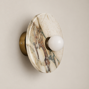 Alba Organic Modern Marble Wall Sconce on a warm greige background; Cream white pink purple marble disc with small white globe