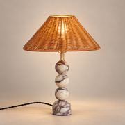 Marble Table Lamp with Natural Rattan Shade on a warm greige background; Natural honey rattan shade; three cream-purple marble spheres