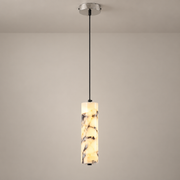 Opus Marble LED Pendant Light on a warm greige background; Creamy brecciated marble, silver canopy, single-head pendant