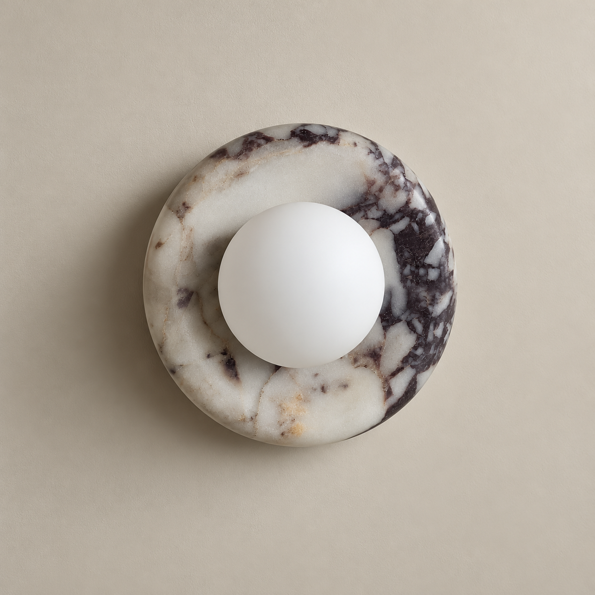 Orli Organic Modern White Marble Wall Sconce on a warm greige background; White marble round breccia disc; white opal globe