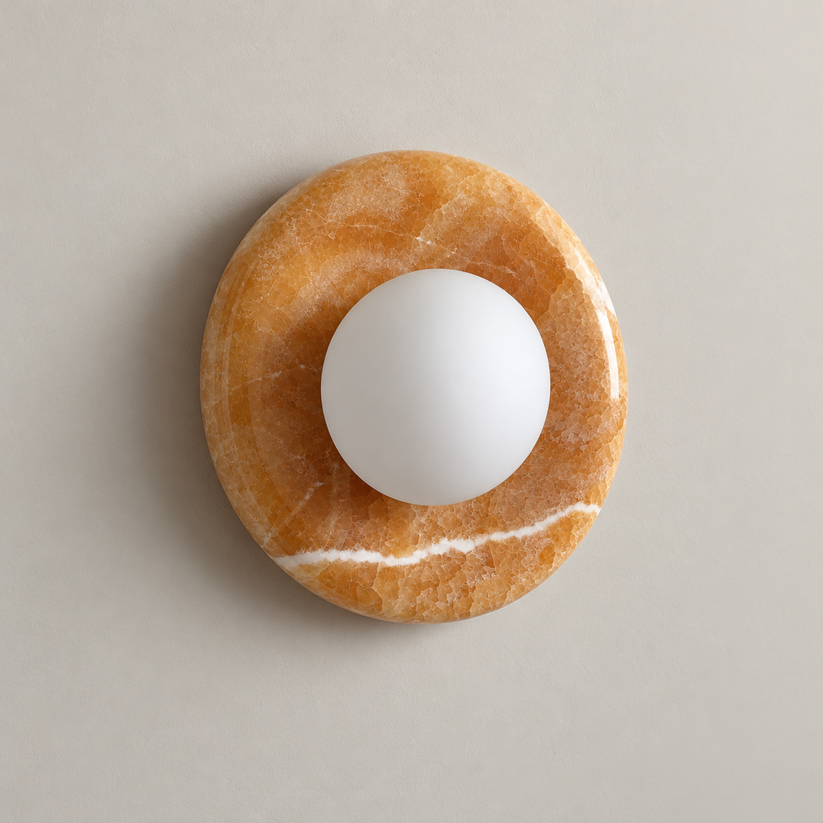 Orli Yellow Onyx Globe Wall Sconce on a warm greige background; Yellow onyx20cm circulardisc with whiteopal center globe