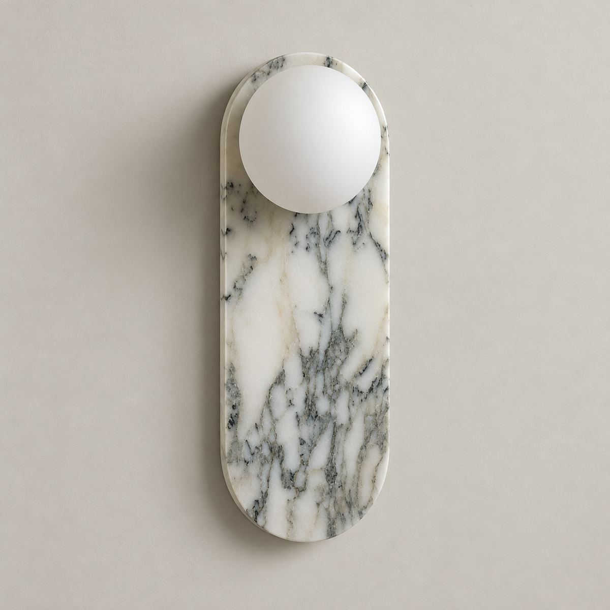 Lucie White Marble Wall Sconce on a warm greige background; White Marble capsule, top globe