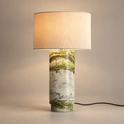 Terra Marble Table Lamp with Fabric Shade on a warm greige background; Terra green marble and ivory fabric drum