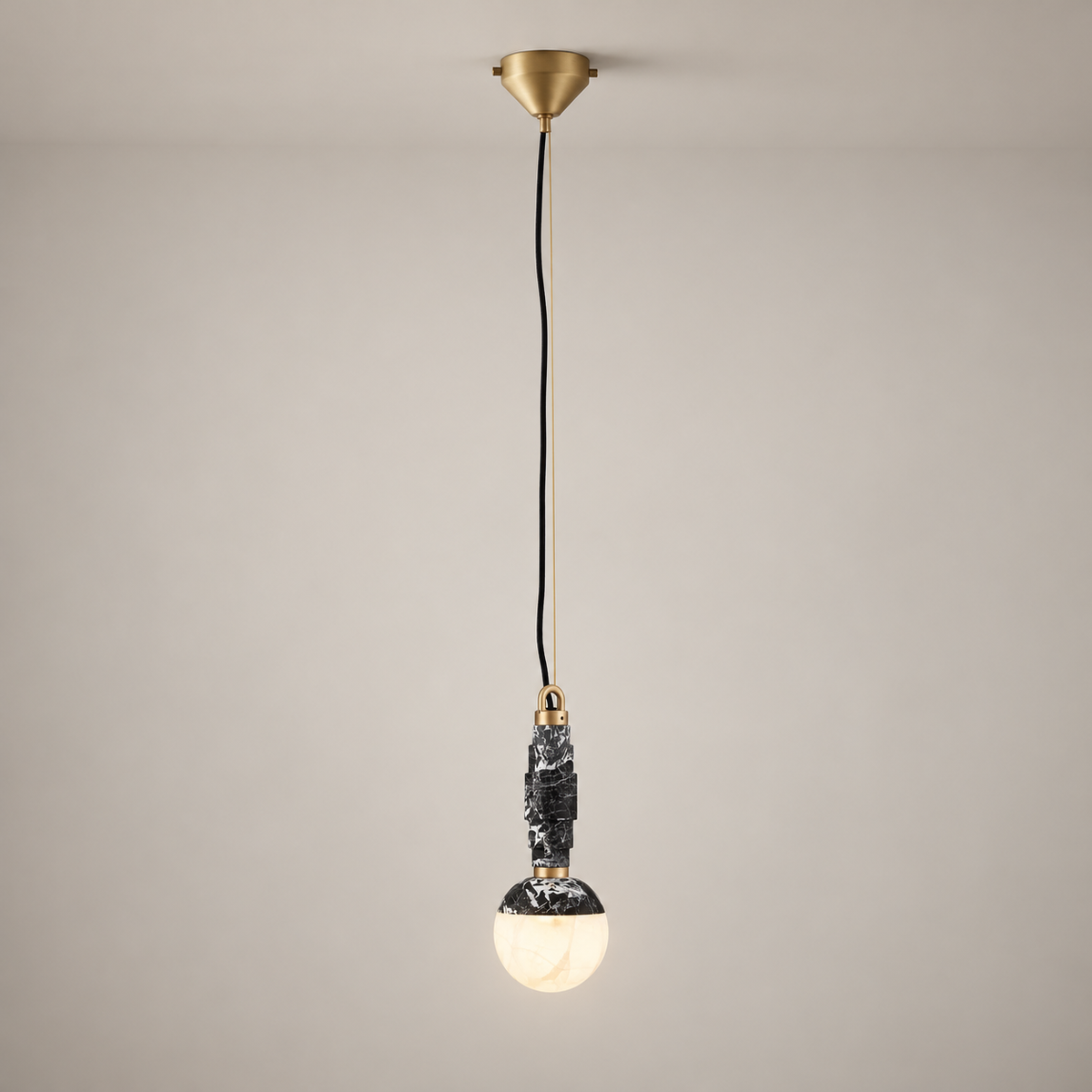 Lunar Art Deco Marble Pendant Light on a warm greige background; Lunar Black A single pendant, long cord