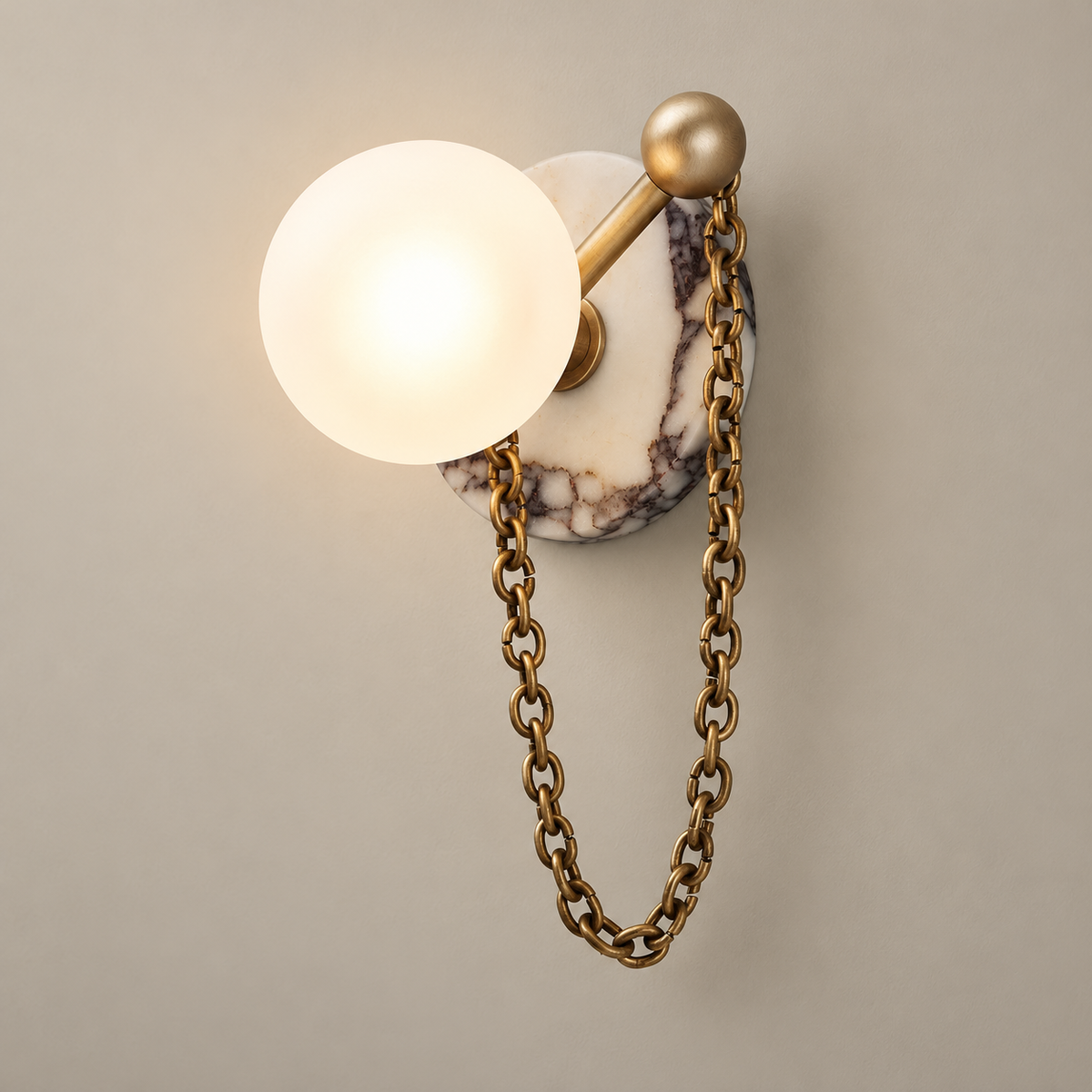 Alla Stone Wall Sconce with Glass Shade on a warm greige background; Alla white marble and brass chain