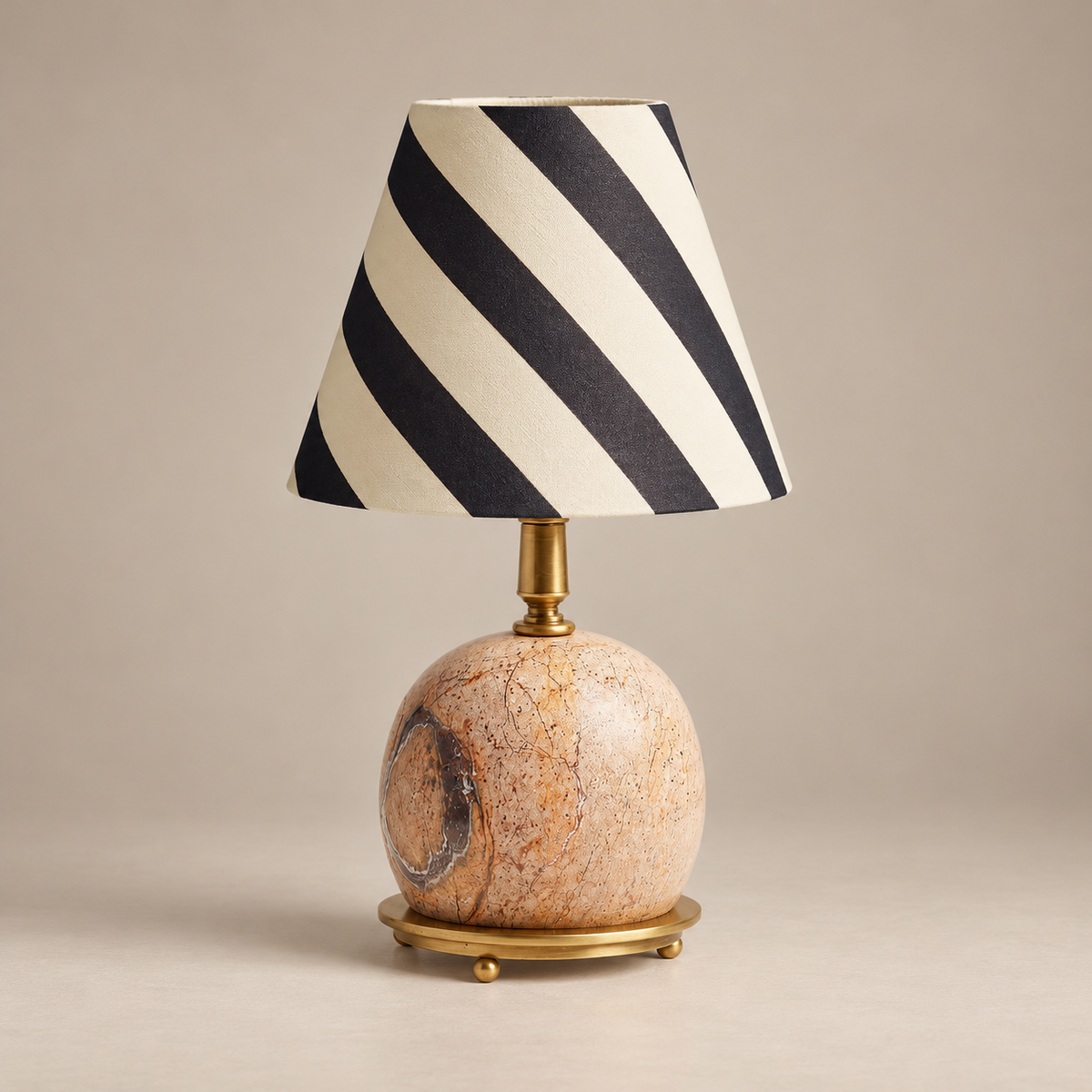 Ferdy Marble Table Lamp with Fabric Shade on a warm greige background; Ferdy pink marble and black ivory stripe shade