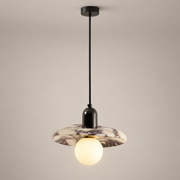 Lu Metal Pendant Light with Marble Shade on a warm greige background; Lu purple marble disc single pendant