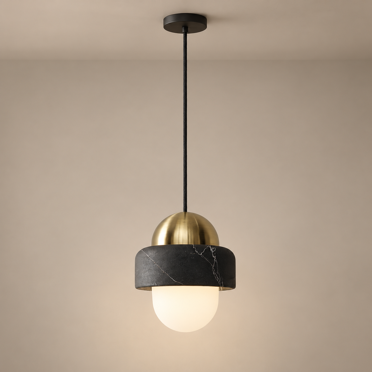 Naga Marble Pendant Light on a warm greige background; Naga black marble weathered brass single pendant