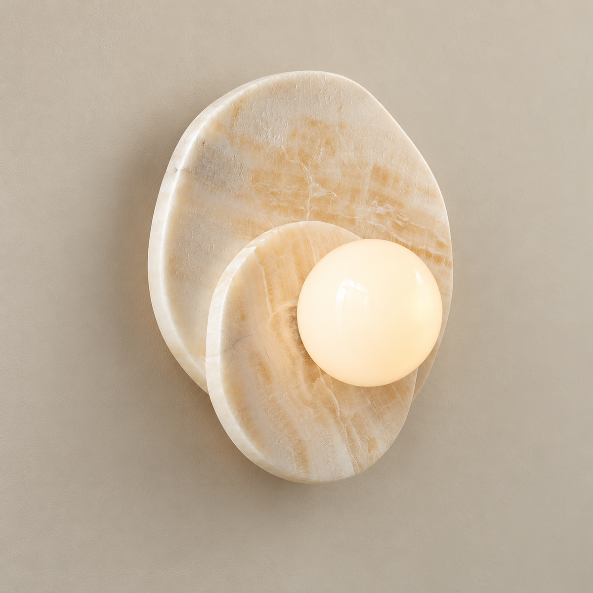 Astr Layered Stone Globe Wall Sconce on a warm greige background; Beige straight onyx, warm globe on