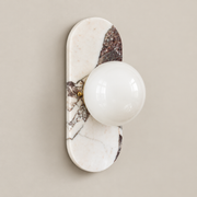 Viola Oval Marble Wall Sconce on a warm greige background; White purple breccia marble, glass globe off