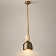 Boston Marble Pendant Light on a warm greige background; Weathered brass, white striped stone beads, long brass rod