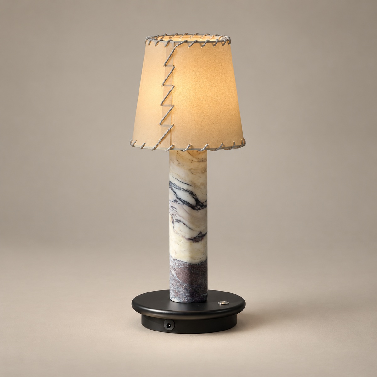 Jorgen Marble Rechargeable Table Lamp on a warm greige background; Model A stitched beige shade, purple marble, black base