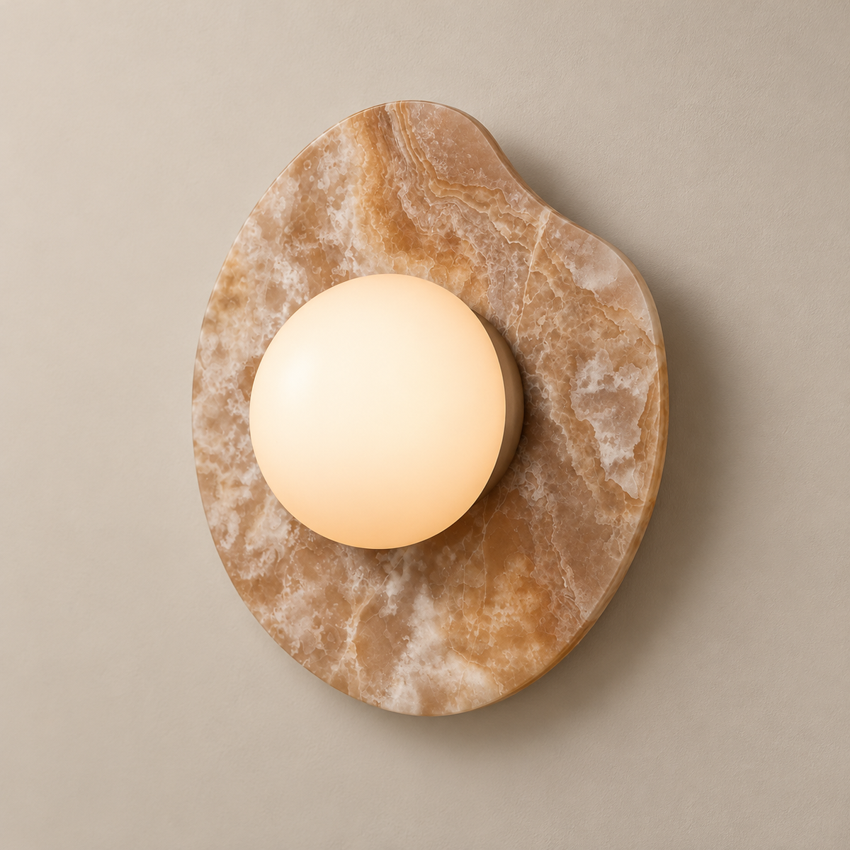 Organic Modern Onyx Nopal Wall Sconce on a warm greige background; Patterned caramel onyx with white glass globe