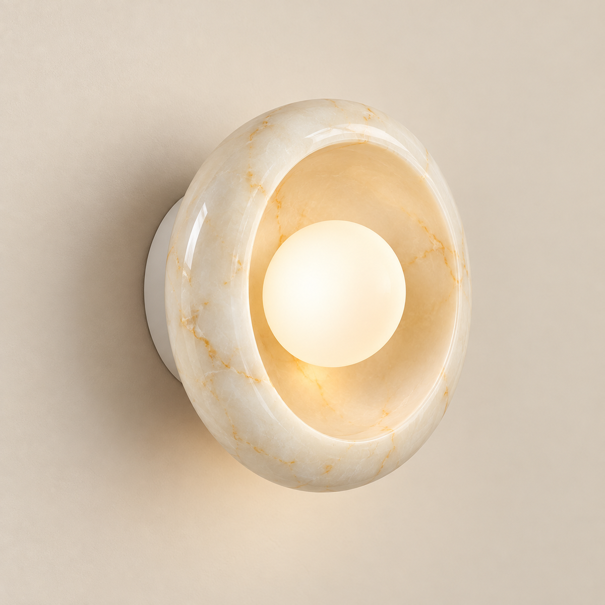 Eclipse Organic Modern Marble Wall Sconce on a warm greige background; Ivory beige marble dish and white glass globe on