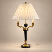 Ellender Marble Table Lamp on a warm greige background; Black marble, ornate brass, ivory pleated shade