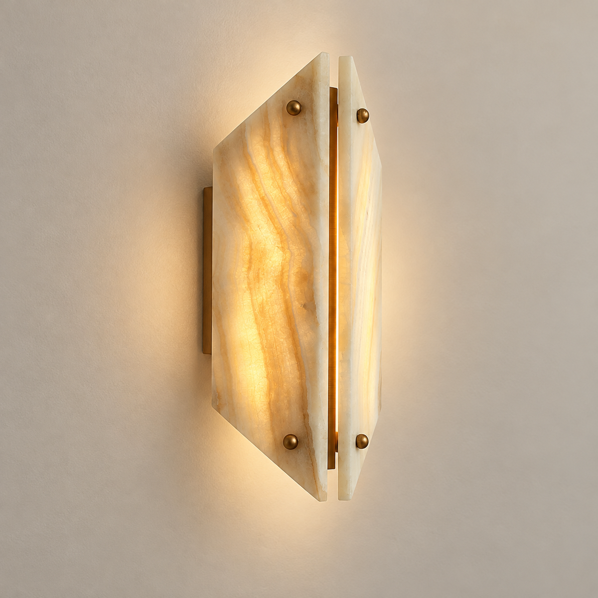 Vivien Stone LED Wall Sconce on a warm greige background; Beige onyx two angled panels and four brass nuts