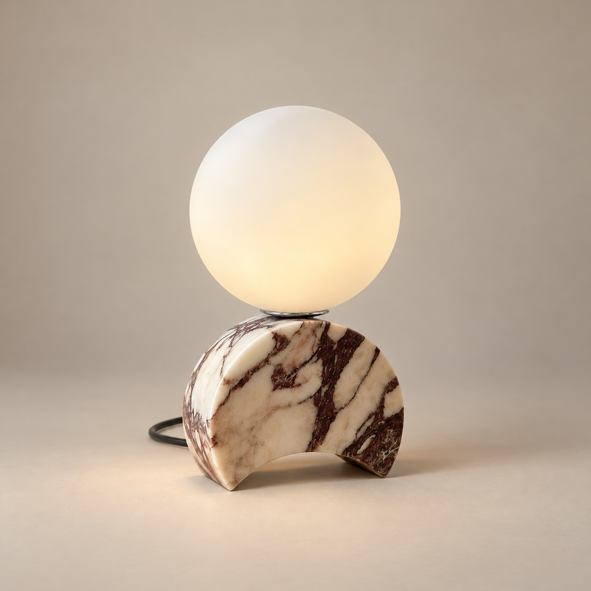 Crescent Mid-Century Marble Table Lamp on a warm greige background; White purple marble crescent base and glass globe