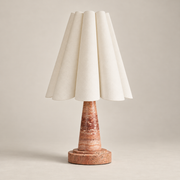 Shadon Traditional Marble Pleated Table Lamp on a warm greige background; Red and white porous stone base, ivory scalloped fabric shade