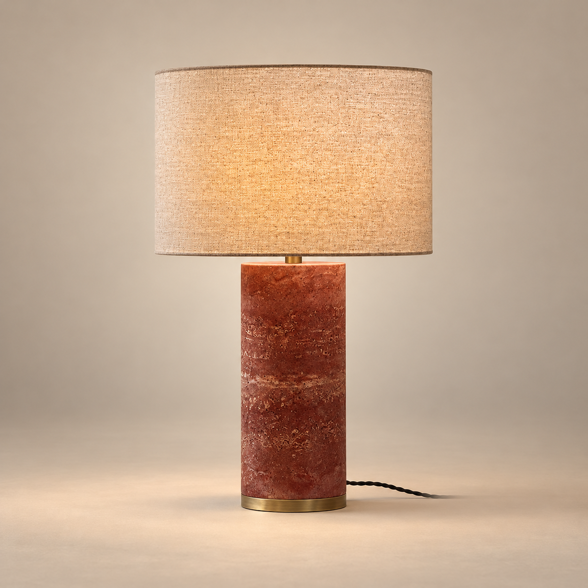 Gravity Marble Table Lamp on a warm greige background; Red cylindrical stone, linen drum shade