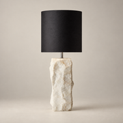Raw Minimalist Marble Table Lamp on a warm greige background; Raw white marble chunk, black fabric drum shade
