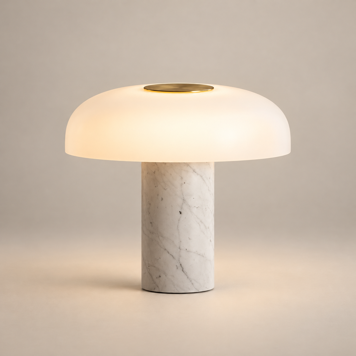 Tropico Marble LED Table Lamp on a warm greige background; White marble cylinder, opal mushroom dome and brass top disk
