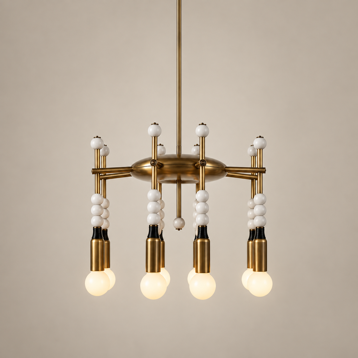 Millie Brass and Marble Chandelier on a warm greige background; Eight heads, antique brass with white stone bead stacks