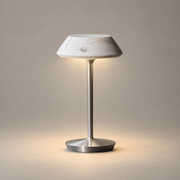 Mini Fiore Marble Rechargeable Table Lamp on a warm greige background; White marble shade, silver metal stem and circular foot