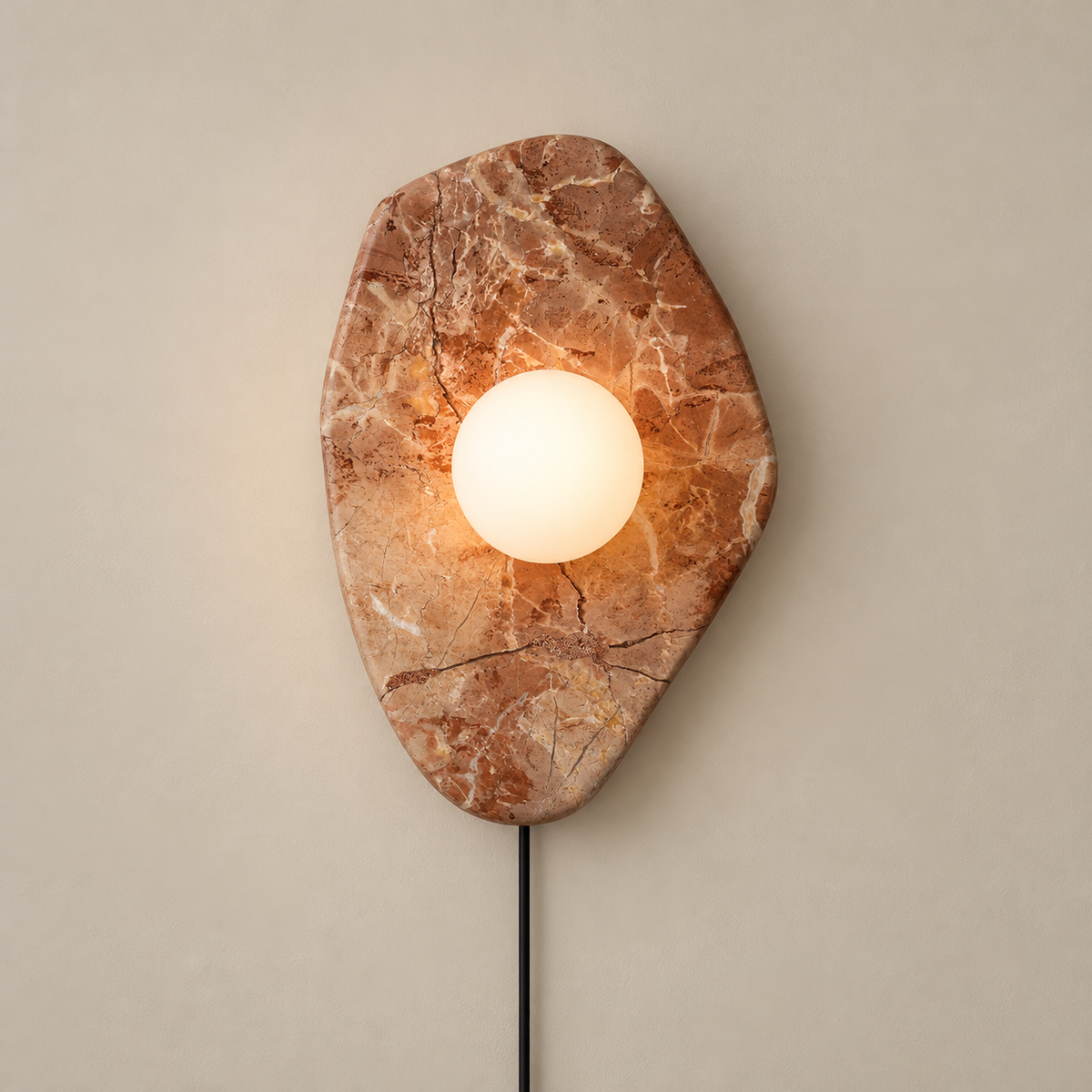 Organic Modern Textured Marble Plug-In Wall Sconce on a warm greige background; Pink organic marble plate and white glass globe, plug in cord