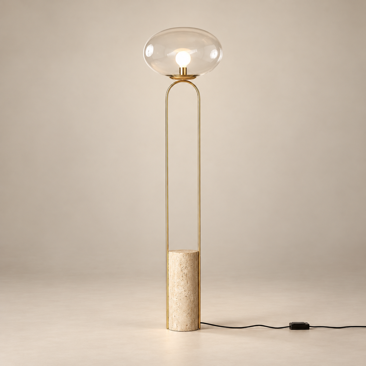 Polo Art Deco Marble Floor Lamp on a warm greige background; Beige travertine brass floor lamp with clear glass shade