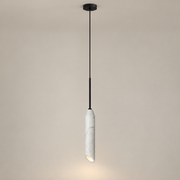 Carnival Minimalist Marble Pendant Light on a warm greige background; White marble and black slim single pendant with long suspension