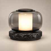 Luna A Marble LED Table Lamp on a warm greige background; Smoke gray glass and black marble LED table lamp