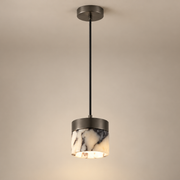 Round Stone Mini Pendant Light on a warm greige background; White purple stone cylinder mini pendant and black mount