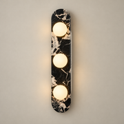 Beatrice Marble Globe Wall Sconce on a warm greige background