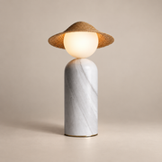Theros Marble Globe Table Lamp on a warm greige background; White marble capsule table lamp woven hat