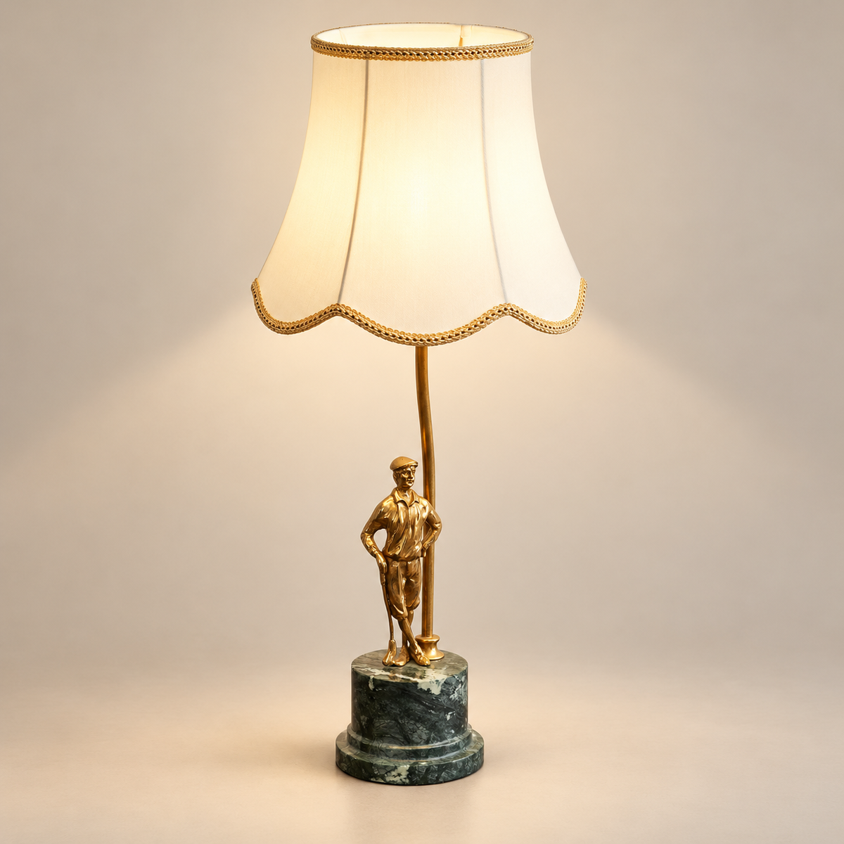 Ellie Brass Table Lamp with Marble Base on a warm greige background; Brass statuette ivory shade green marble base