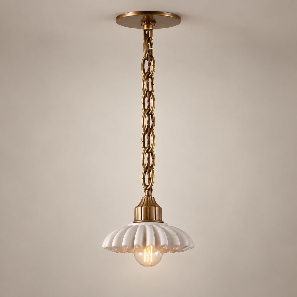 Lola Marble Pendant Light on a warm greige background; Lola long chain single pendant